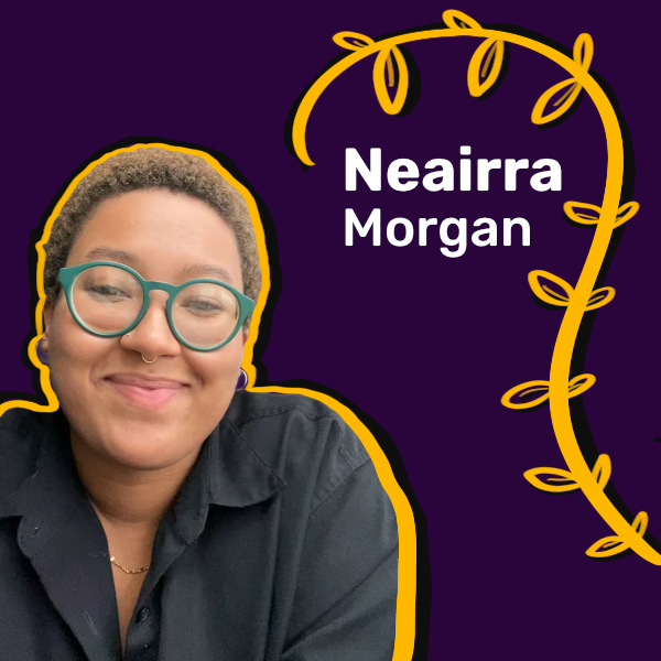 A smiling Black person with glasses and a teeny weeny Afro